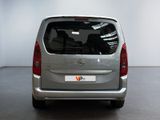 the rear view of a silver van parked in a garage