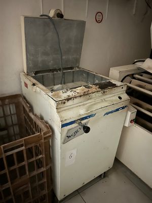 an old refrigerator that is sitting in a room