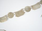 a silver bracelet that has five different shapes on it