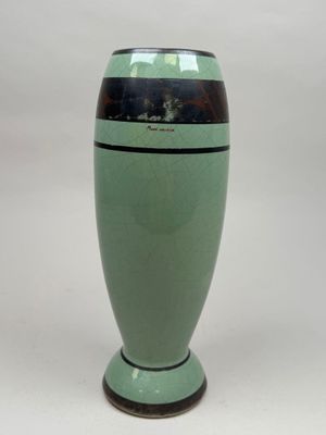 a green vase with a black stripe on it