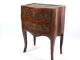 a small wooden chest of drawers on a white background