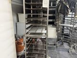 an image of a kitchen with a bunch of racks of food