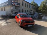 a red car parked in front of a building in a parking lot