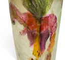 a vase with a flower inside of it on a white surface