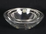 a glass bowl that is sitting on a black surface