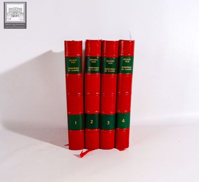 three red books sitting on top of each other on a white surface