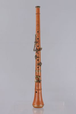 a clarinet with a wooden body and brass handles