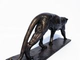 an image of a bronze statue of a cat on a marble base