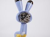 an image of a blue and yellow bunny figurine on a white background