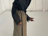 figurine of an old woman with a black robe and a black hat