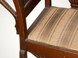 a wooden bench with a cushion on top of it
