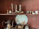 a shelf that has a lot of silver items on it