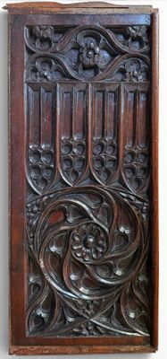 carved wood panel with a design of flowers and vines
