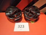 two helmets are sitting on top of a table with a price tag