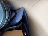 a stack of blue chairs and a blue pan on top of a cardboard box