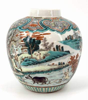 a vase with a painting on it sitting on a table