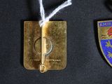 two medals that are on display on a black surface