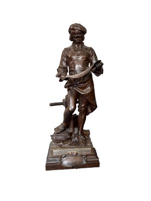 bronze statue of a man holding a dog and a bird