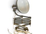 a light that is attached to a wall next to a bunch of clothes