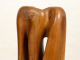 wooden sculpture of a woman ' s torso on a white pedestal
