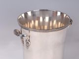 an antique silver plated ice bucket with handles on a white background