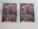 two pokemon trading cards in plastic cases on a white surface