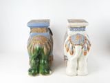 two vases with elephants on them sitting next to each other