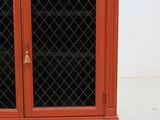 a red cabinet with a glass door and a door handle