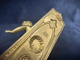 gold plated door handle with a lady and a bird on it
