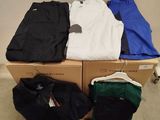 a lot of clothes that are sitting on top of a box