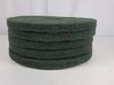 four green sponge pads stacked on top of each other on a white surface