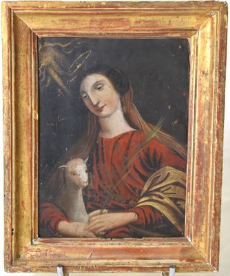 un vieux tableau représentant une femme tenant un chat, dans un cadre doré