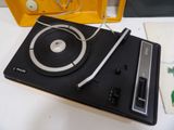 a turntable that is sitting on a table next to a yellow box