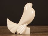 a white bird that is sitting on a wooden table