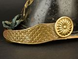a helmet that has a gold flower on the side of it