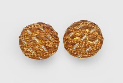 a pair of gold and diamond earrings