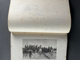 an old book with a picture of a group of men riding horses
