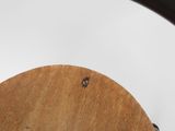 a close up of a wooden chair with a black seat