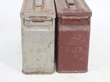 two old metal boxes sitting side by side on a white surface
