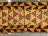 a brown and black rug on a table in a room