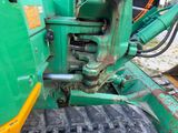 a close up of a green machine with a tire