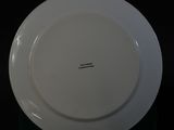 a white plate with a black writing on it on a table