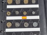 a lot of different coins in a binder on the table