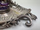 a purple vase sitting on top of a silver tray
