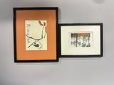 two framed pictures hanging on the wall of a room