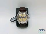 a close up of a watch on a stand on a white surface