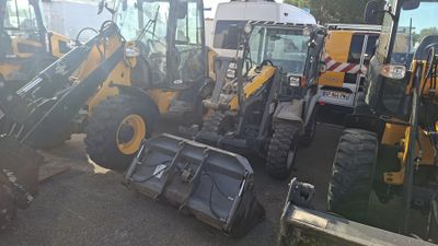 many construction vehicles that are parked in the parking lot