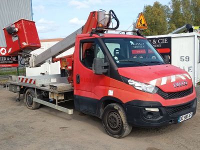 a red truck with a crane on the back of it
