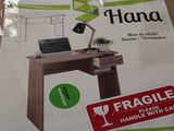 a box with a picture of a desk with a laptop on it