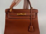 a brown leather handbag on a white background
